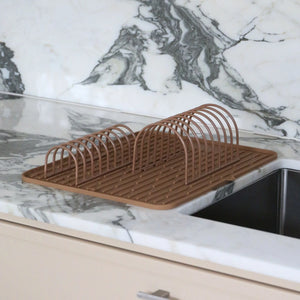 Brown dish rack on a marble kitchen counter