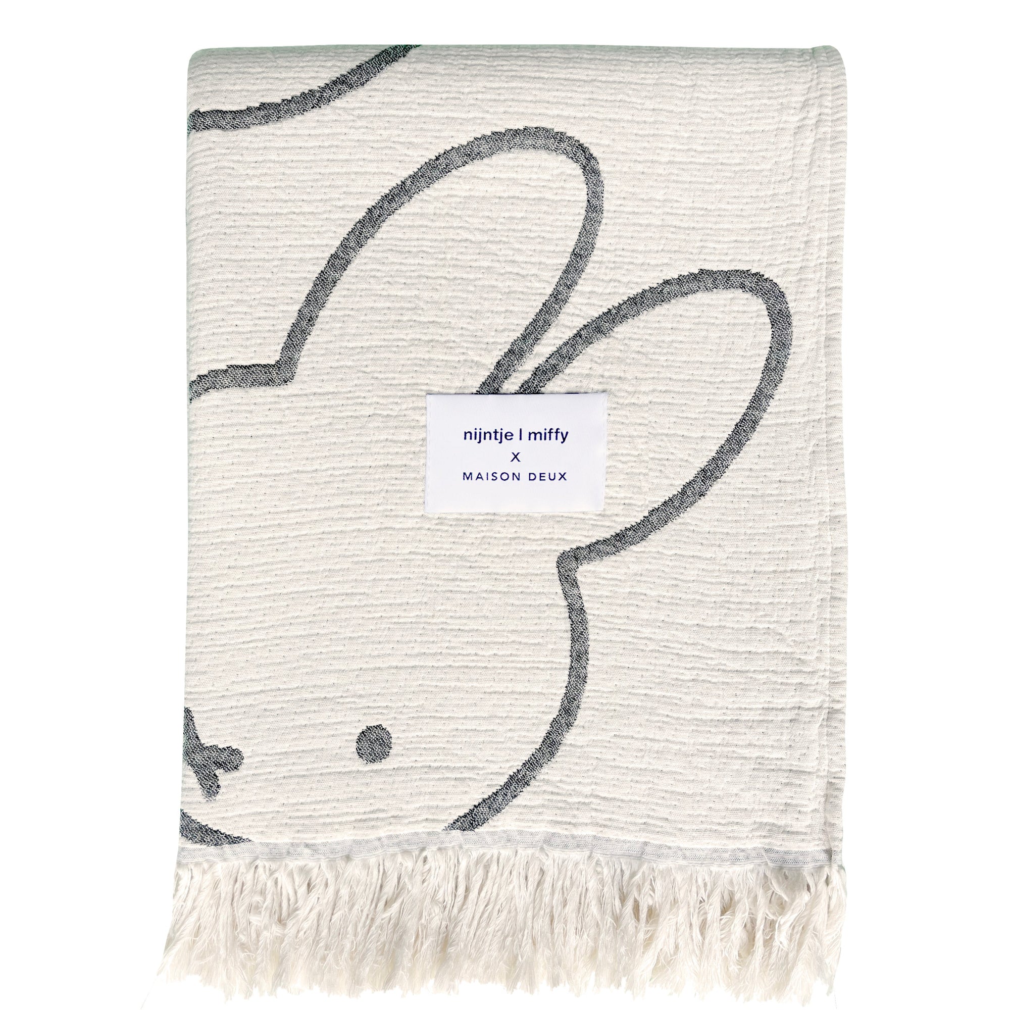 Miffy Cotton Blanket Black, jacquard-woven 100% cotton with fringed short sides and all-over Miffy print.