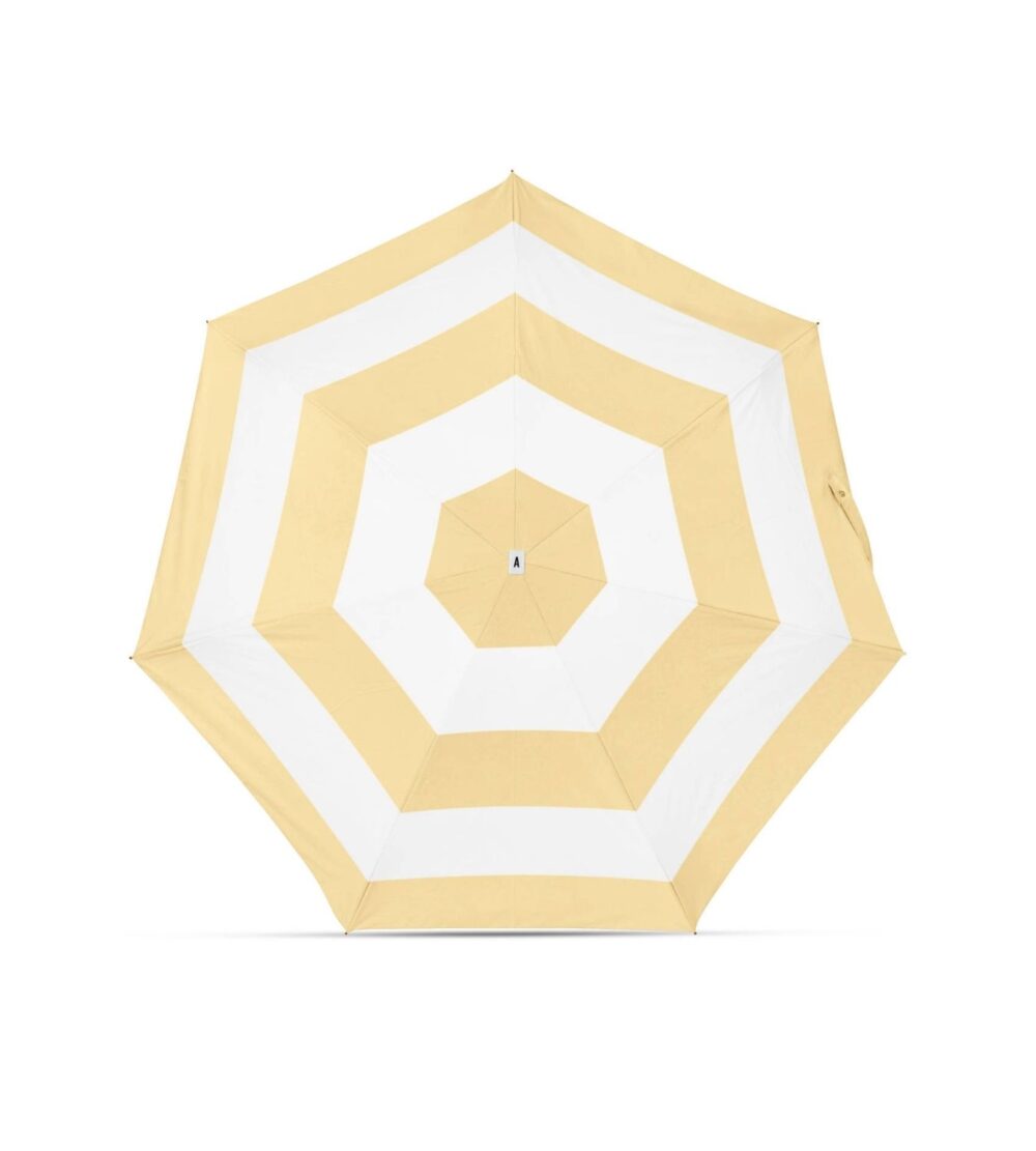 Yellow and white umbrella with 'Anatole' packaging on a white background