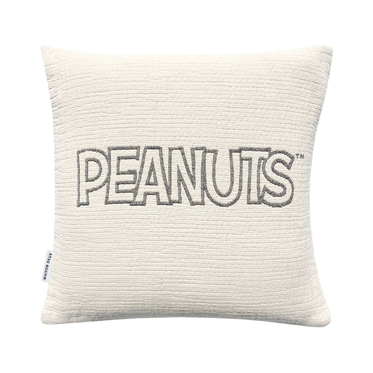 Textured pillow with 'PEANUTS' embroidery on a white background