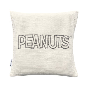 Textured pillow with 'PEANUTS' embroidery on a white background