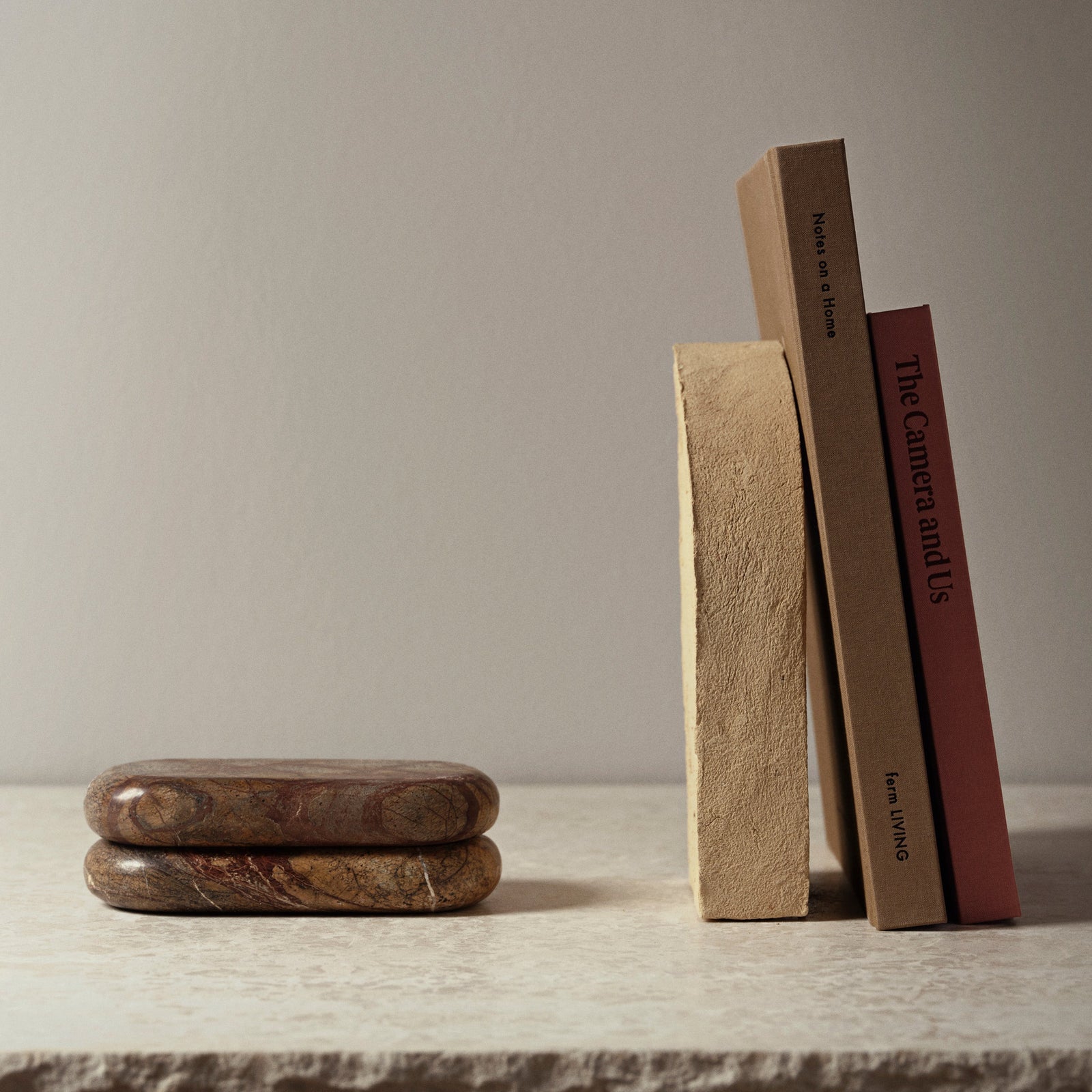 Two stacked stone-like objects on a white background