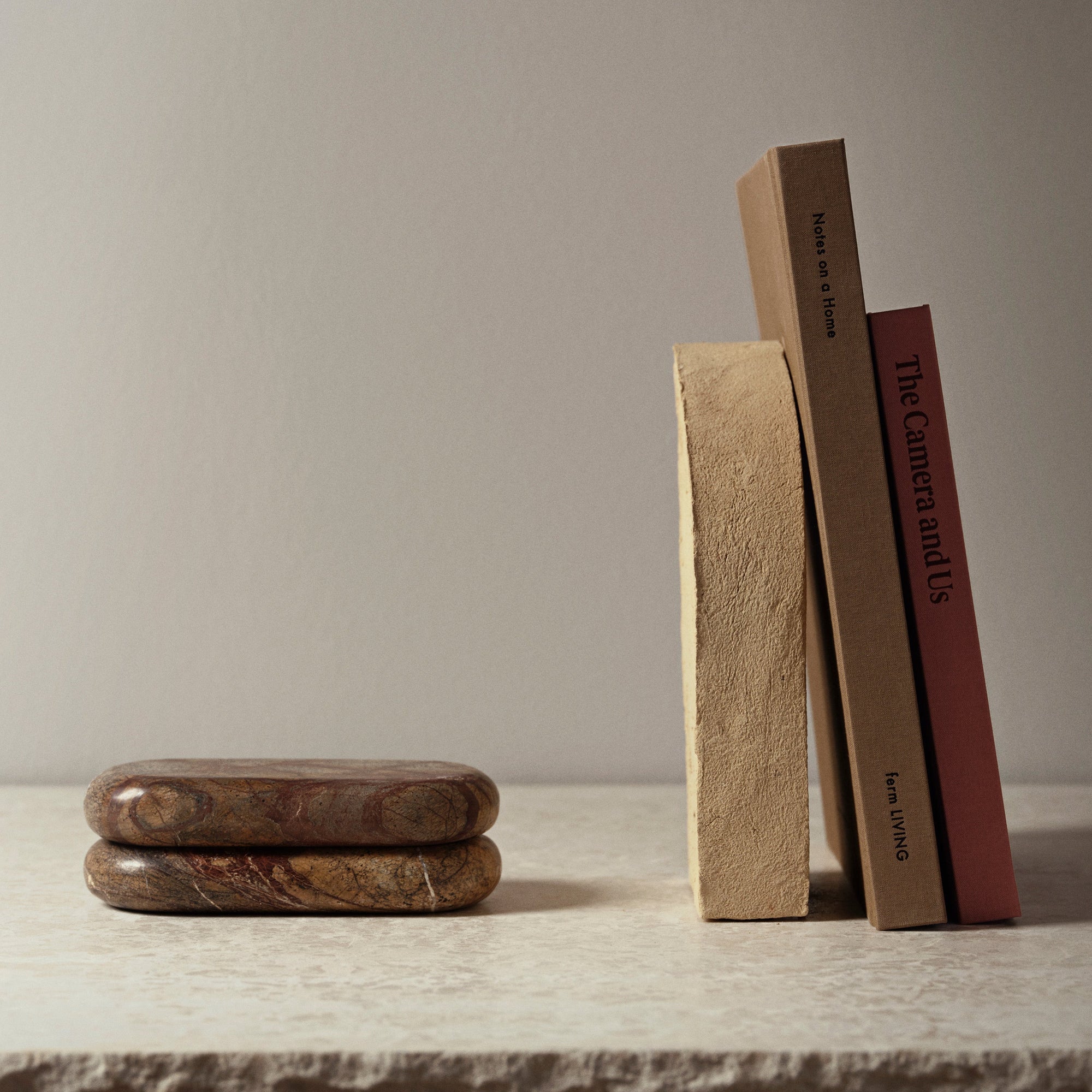 Two stacked stone-like objects on a white background