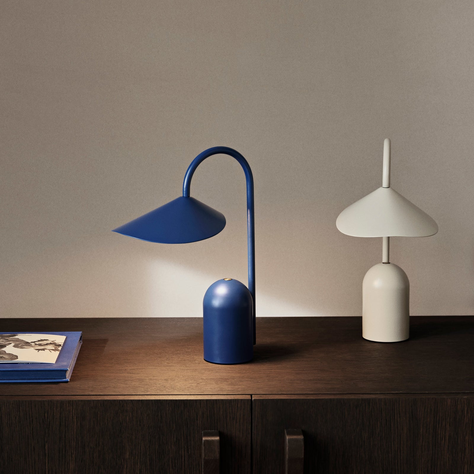 Arum portable Blue table lamp with curved arm on a white background